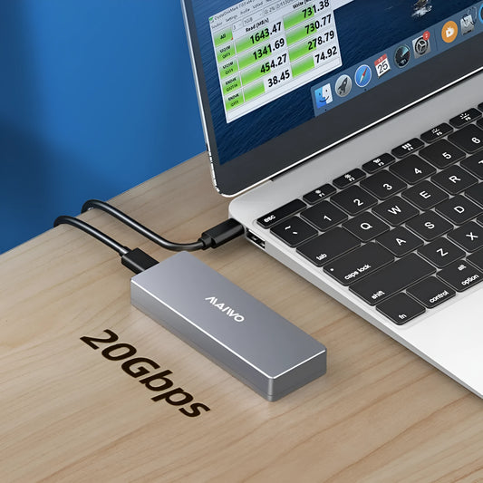 Silver aluminium M.2 NVMe SSD external enclosure with USB Type-C port, cables, and screwdriver on a desk.