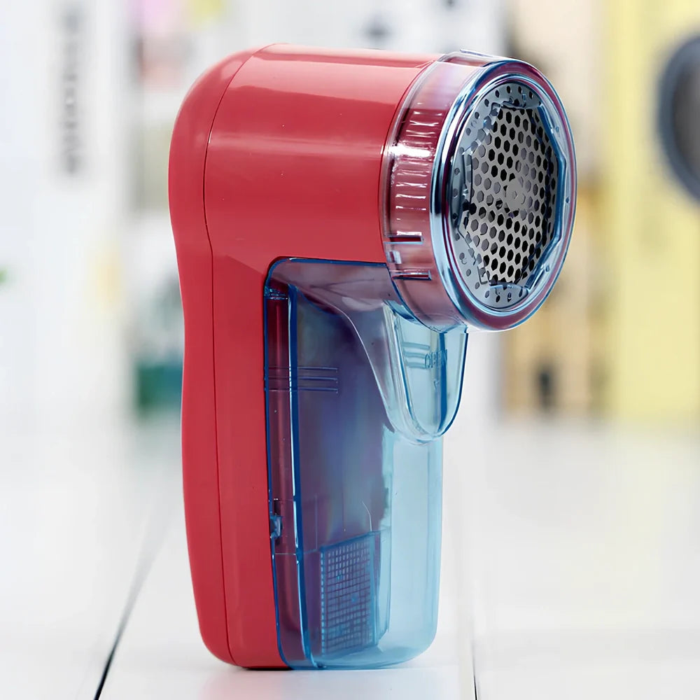 Portable electric lint remover device measuring 11x16x9.5cm with USB charging cable