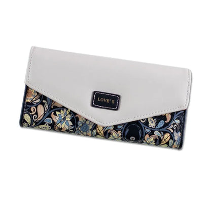 Three-fold leather wallet with buckle closure showing black colour variant, note clip visible inside compartment