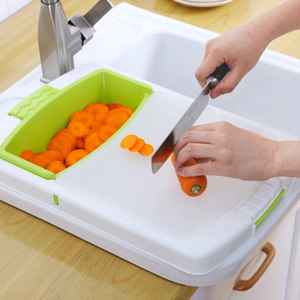 Green multifunction cutting board with drainage holes and storage trough mounted on a kitchen sink.