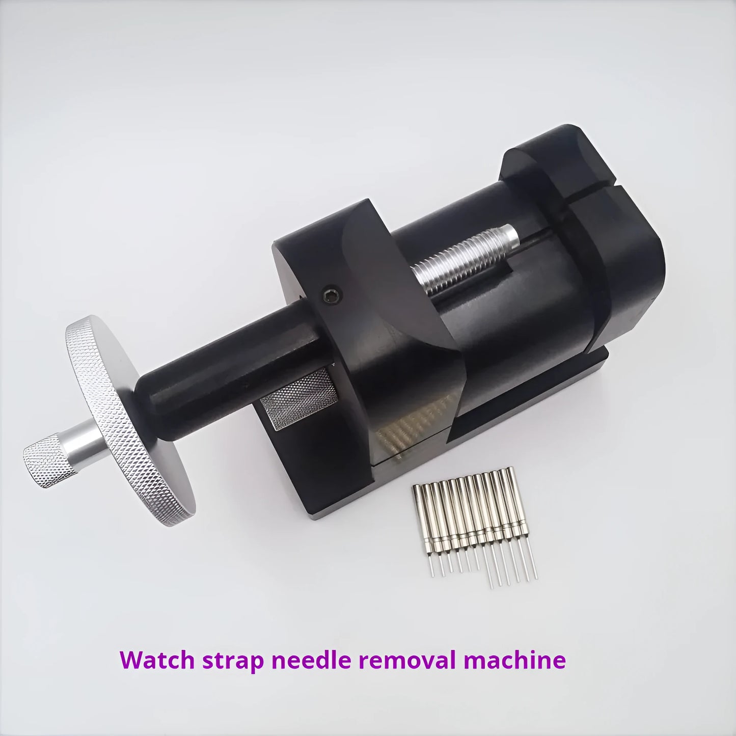Alloy steel watch strap removal tool for watch repair on a workbench.