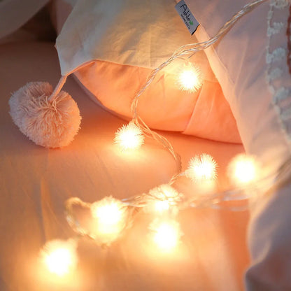 Battery-operated LED Christmas curtain garland with plastic stars and fur balls