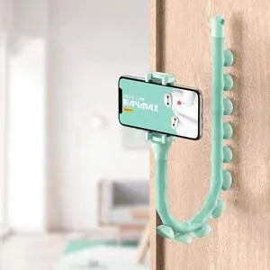 Black flexible gooseneck phone holder with suction cup mounted on a desk, holding a mobile phone at an angle.