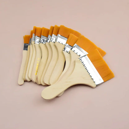 Nylon bristle paint brush with wooden handle measuring 14-18cm length in raw wood colour