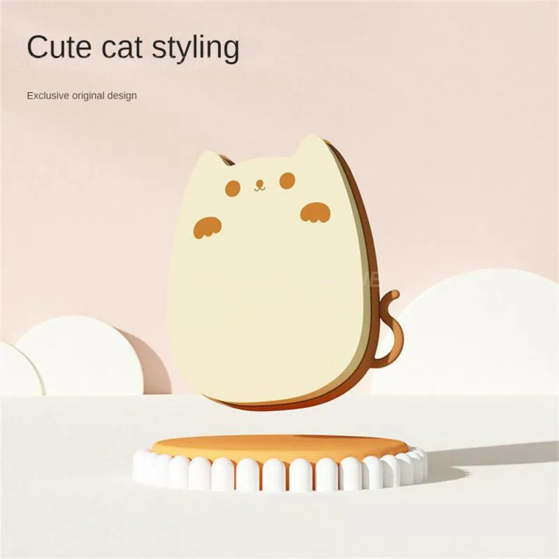 Blue silicone and sponge pet grooming brush with dual comb teeth on a wooden surface.