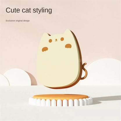 Blue silicone and sponge pet grooming brush with dual comb teeth on a wooden surface.