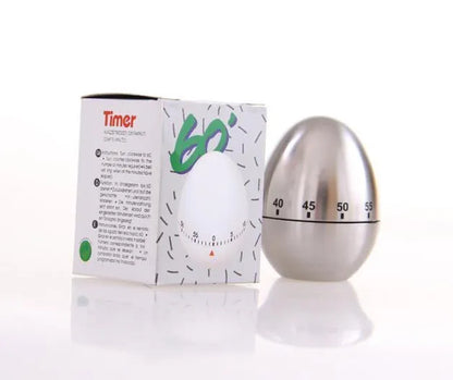 Stainless steel mechanical kitchen timer with egg-shaped design on kitchen counter