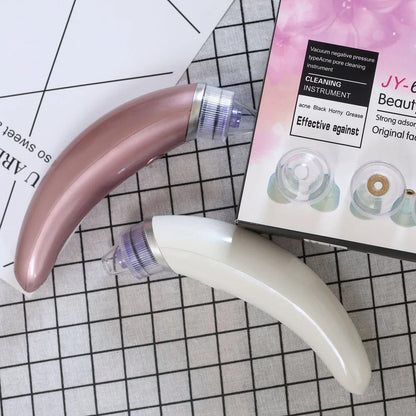 Electric blackhead suction instrument in rose gold and white colours for facial pore cleansing