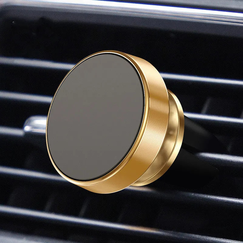 Black magnetic car phone holder with 360-degree ball joint mounted on a car air vent, holding a smartphone.