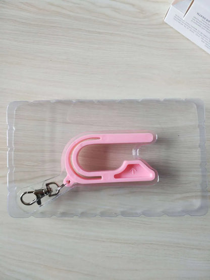 Plastic car seat key for child car seat red button, shown in Pink, Violet, or green, stored on a keychain.