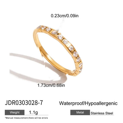 Geometric titanium steel zircon ring in stainless steel on a grey background.