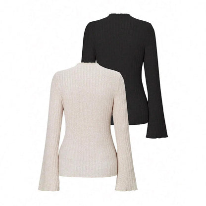 Long sleeve round neck top in black with lantern sleeves and slim fit, on a hanger