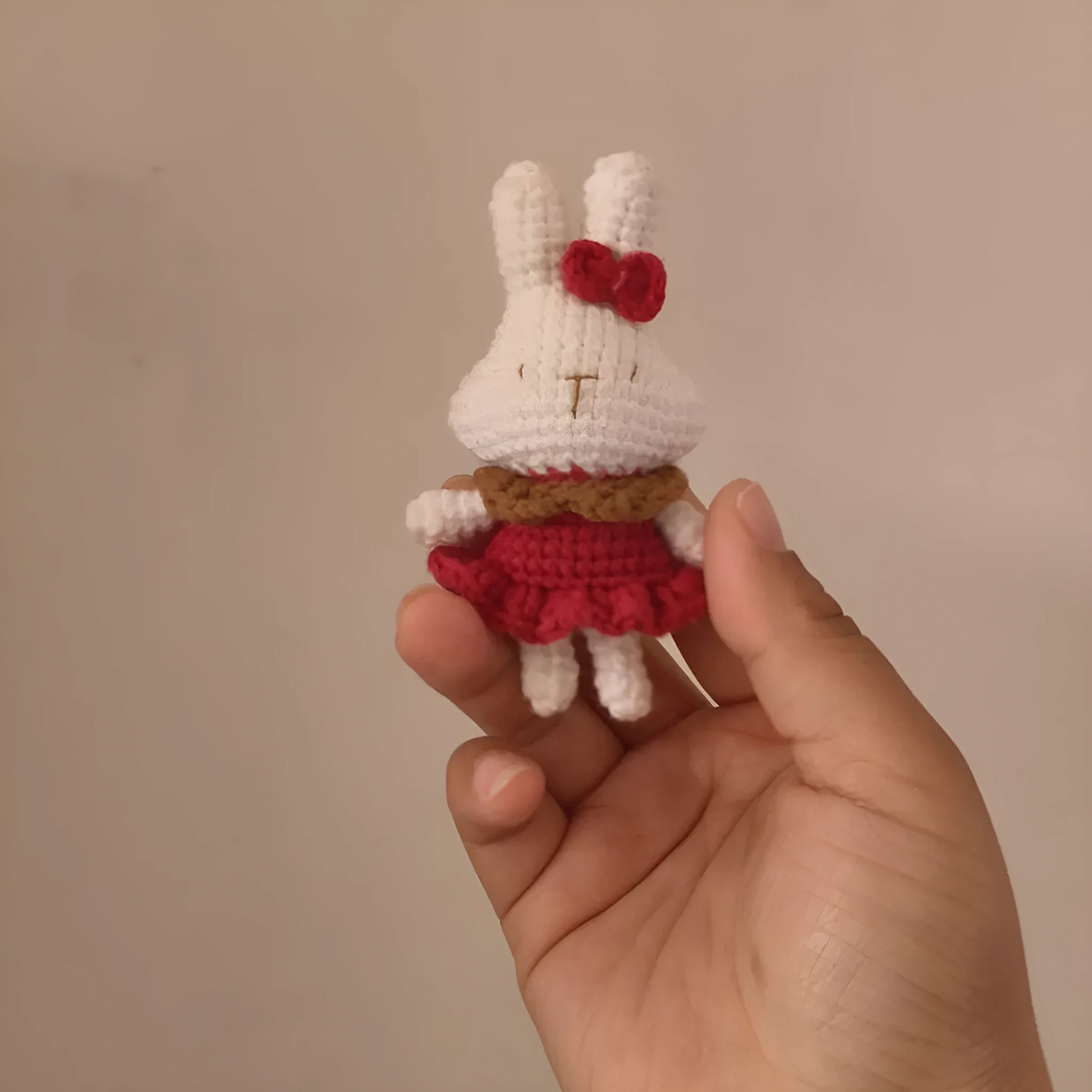 Hand-crocheted wool yarn rabbit keychain pendant with decorative design