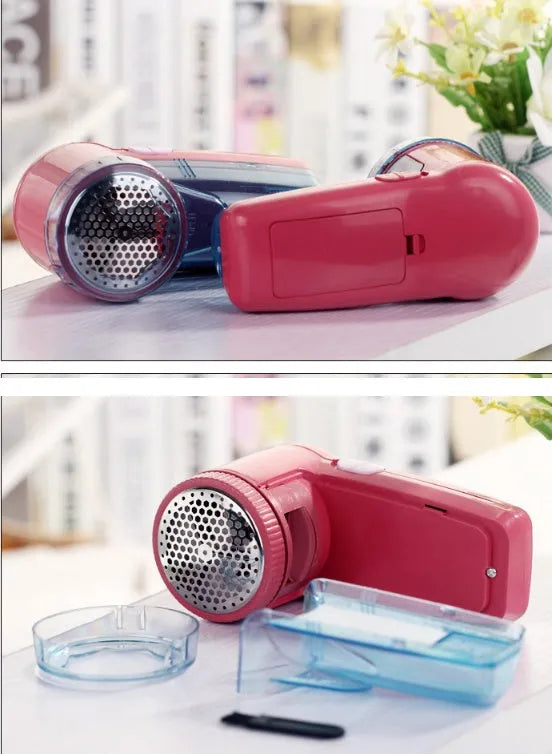 White portable electric lint remover on a blue sweater, showing compact size and shaver head.