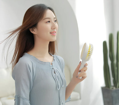 Blue shaking head handheld fan showing oscillating mechanism and USB charging port