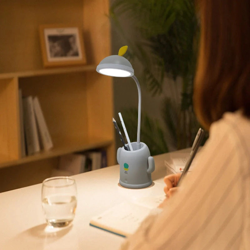 Cactus-shaped table lamp with pen holder and USB cable, available in green, pink, and grey