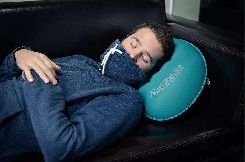 Compact inflatable travel pillow in peacock blue, bright orange, or green for camping and outdoor use