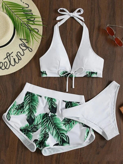 A stylish 3-piece swimsuit set featuring a unique leaf print design, including a top, bottoms, and matching shorts.