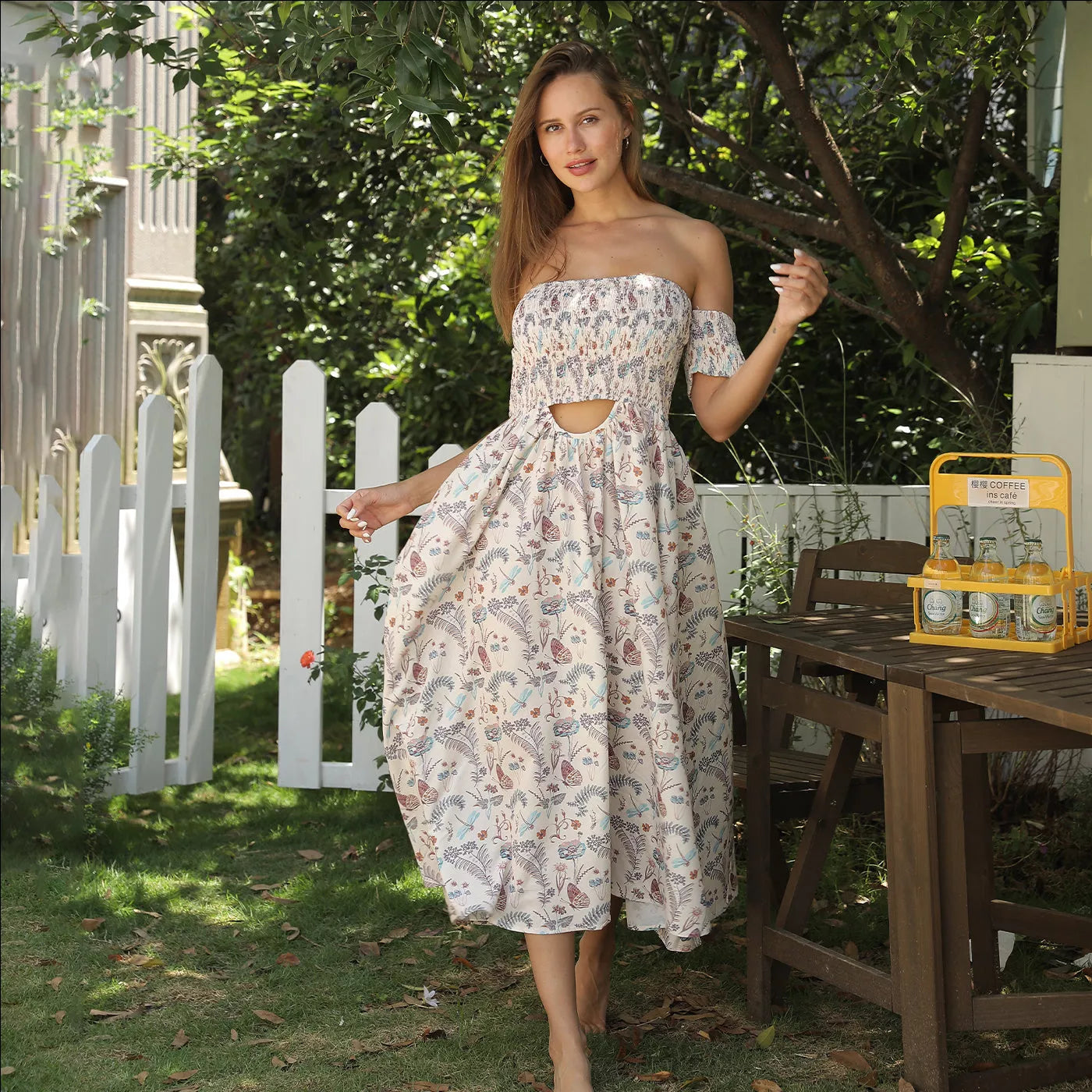 Women's off shoulder strapless floral dress in a lightweight fabric, available in multiple sizes.