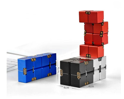 Zinc alloy Infinity Cube with eight rotating cubes showing black and silver colour options on wooden surface