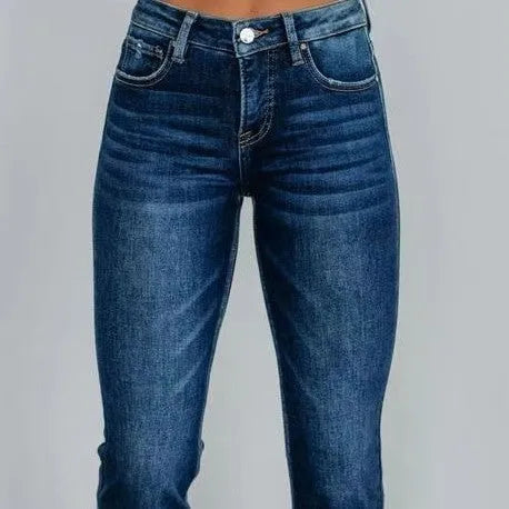 Women's solid colour denim trousers with hand-worn finish in dark blue, showing casual styling and 100% cotton construction