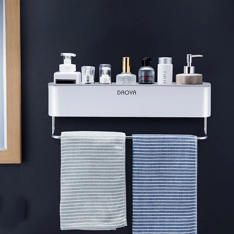 Plastic bathroom wall shelf with hole-free installation in a grey finish, holding shampoo and shower gel bottles.