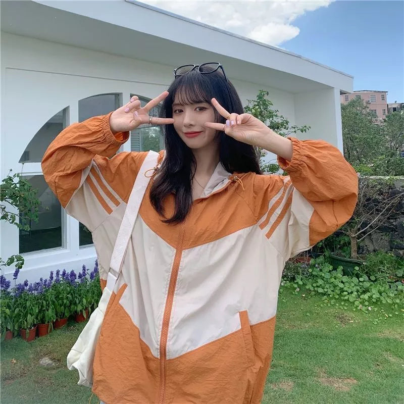 Women's lightweight hooded sun protection coat in blue, red, or orange