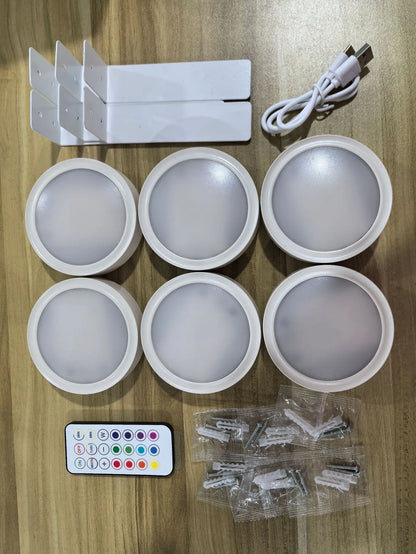 Black magnetic LED painting lamp with remote control on a white wall.