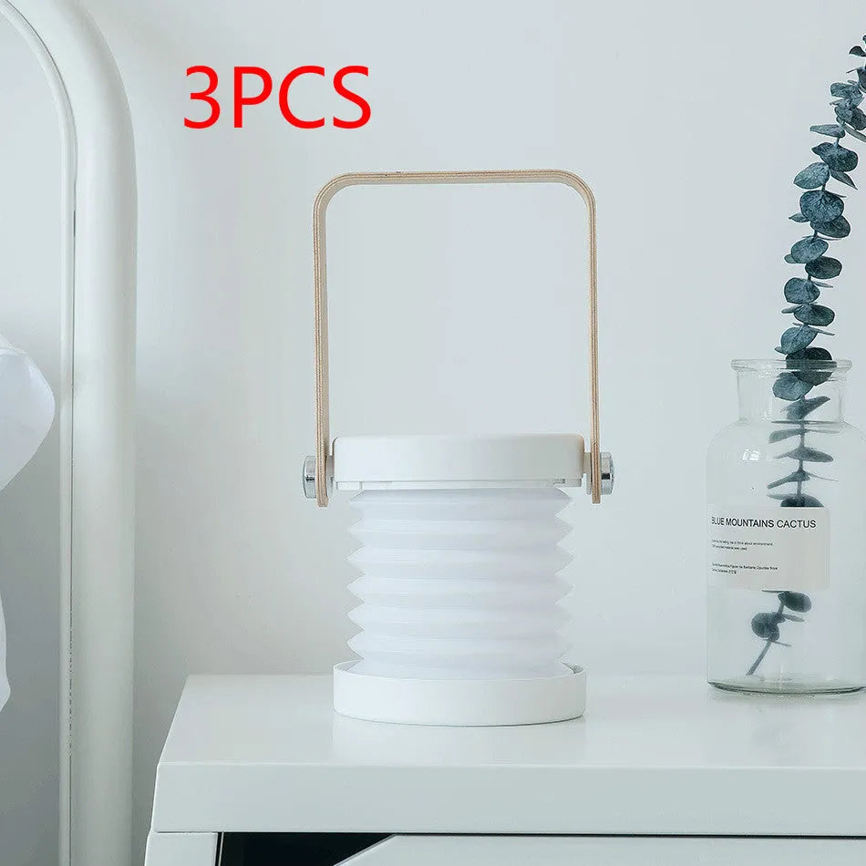 White foldable USB rechargeable LED night light in both table lamp and tall lantern modes.