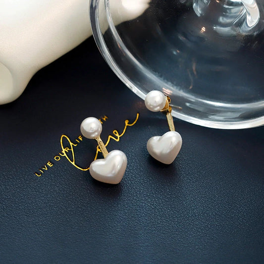 Elegant heart-shaped pearl stud earrings for women, perfect for gifts or personal style.