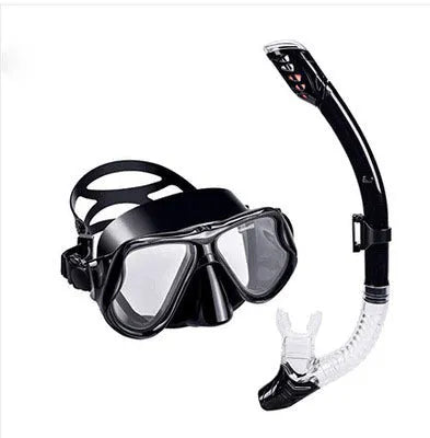 Black diving goggles with transparent anti-fog lens, adjustable silicone strap, and PC frame showing replaceable lens system
