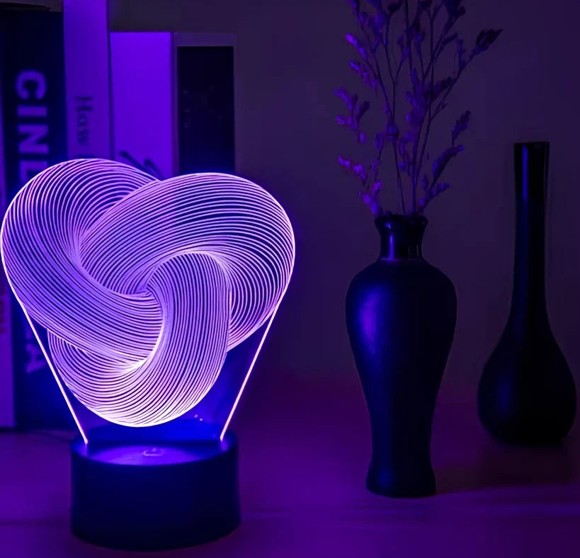 Twist abstract LED 3D night light with acrylic construction showing colour gradient illumination on dark surface