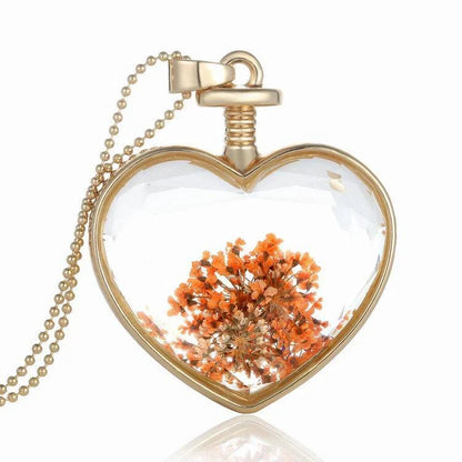 Elegant round pendant necklace with dried flower specimen in various colors including yellow, blue, purple, red, and orange