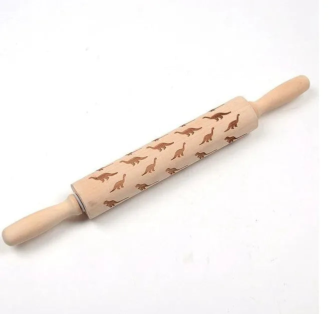 Wooden rolling pin with engraved Christmas patterns including reindeer and snowflakes on a 45cm long barrel.