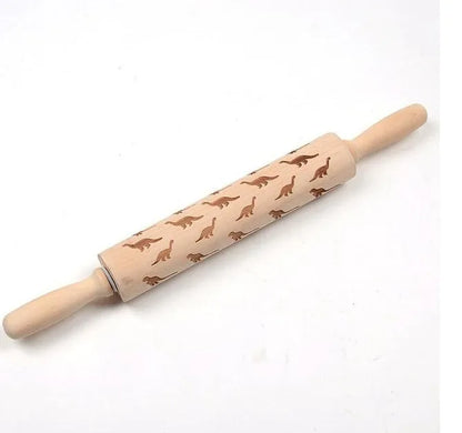 Wooden rolling pin with engraved Christmas patterns including reindeer and snowflakes on a 45cm long barrel.
