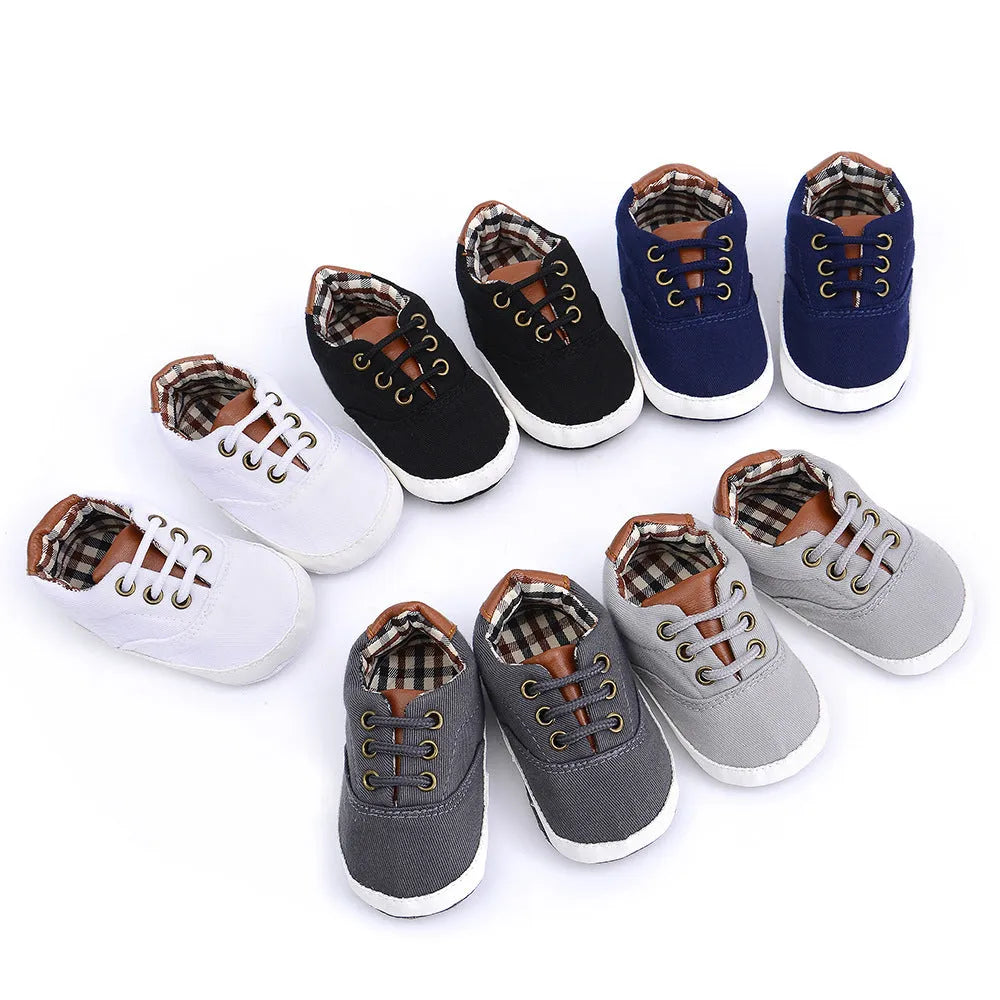 Baby canvas shoes in solid colour with soft bottom and front strap, sizes 11cm to 13cm