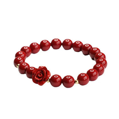 Close-up of a handmade purple gold sand cinnabar rose bracelet with an 8mm bead.