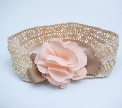 A charming flower headband for babies, featuring a delicate floral design and adjustable fit for a comfortable, stylish accessory.