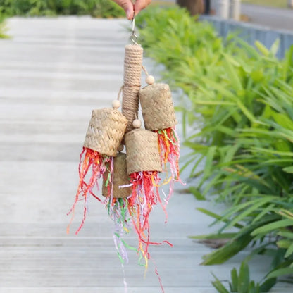 Wooden parrot chew toy with colourful shredded paper measuring 15x35cm
