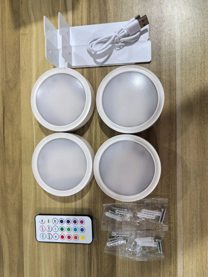 Black magnetic LED painting lamp with remote control on a white wall.