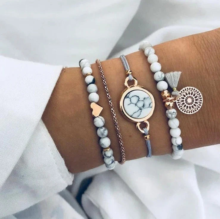 A four-piece geometric pine stone bracelet set made of alloy with an electroplated finish and resin stones, offering a sleek and versatile fashion accessory.