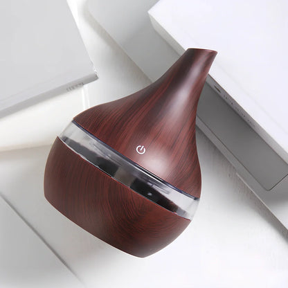 Round wood grain humidifier with USB cable on wooden surface