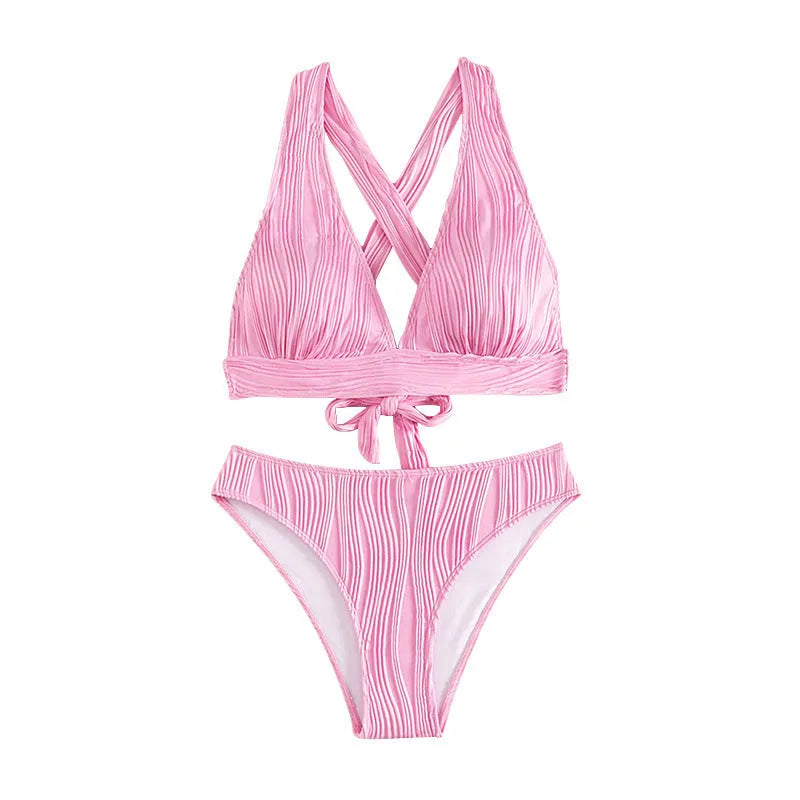 Pink women's halter neck bikini top and matching split-style shorts on a mannequin.
