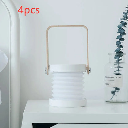 White foldable USB rechargeable LED night light in both table lamp and tall lantern modes.