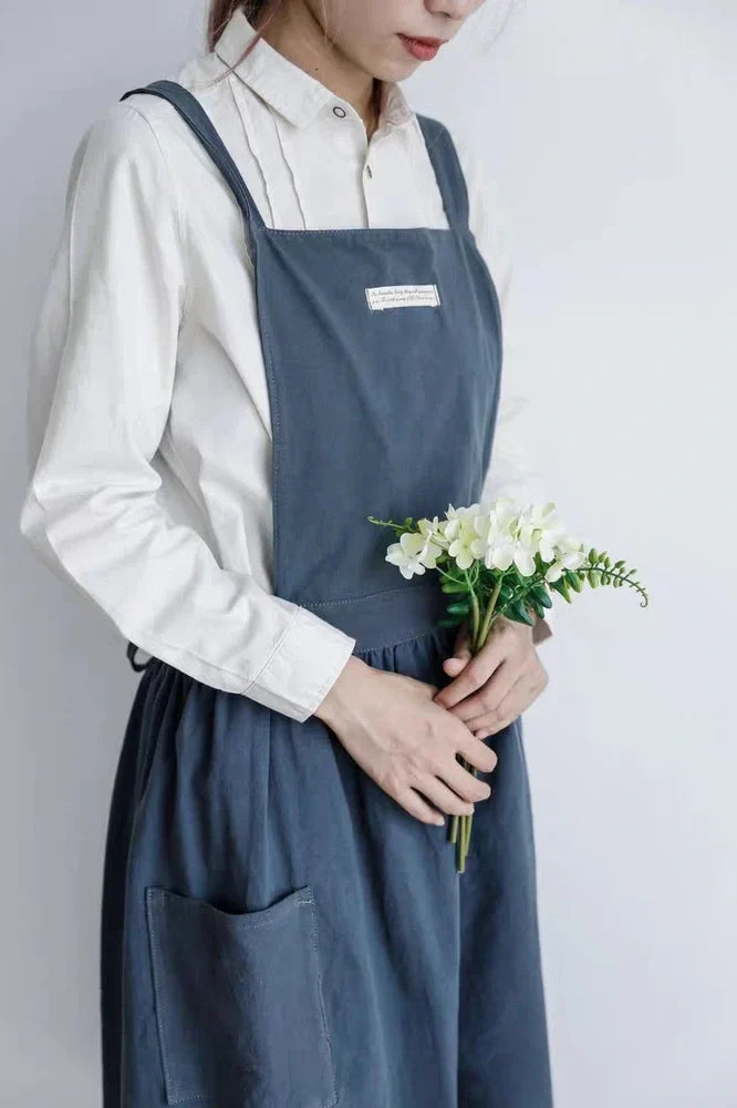 Sleeveless cotton kitchen apron in blue colour showing front coverage and adjustable neck strap