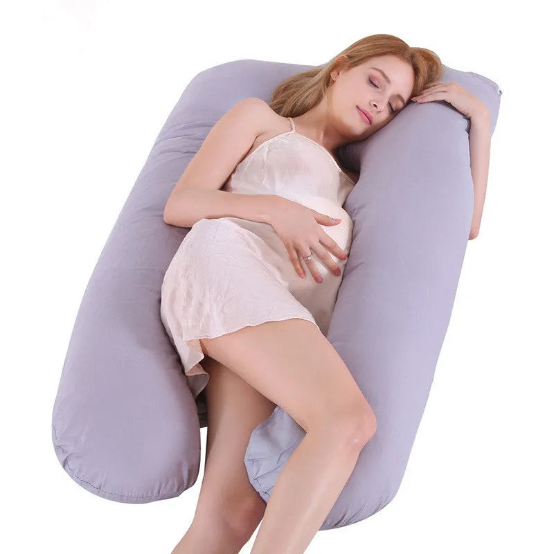 Large U-shaped pregnancy support pillow with removable cover and abdominal support belt.