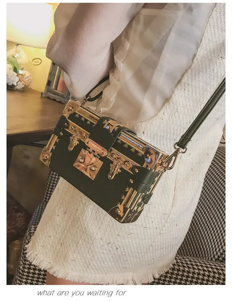 Women's hard flap shoulder bag in black or green with single adjustable strap and rivet decoration