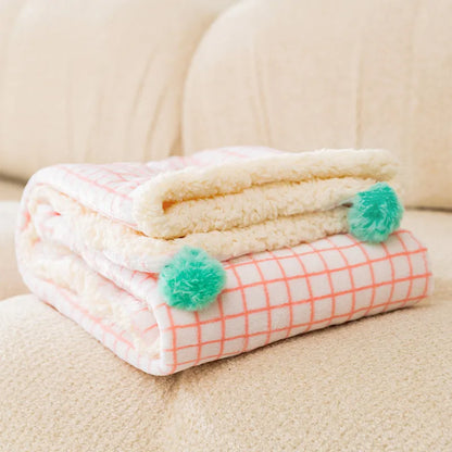 Blue coral fleece pet blanket shown in a Large size (70x50cm) on a wooden floor.