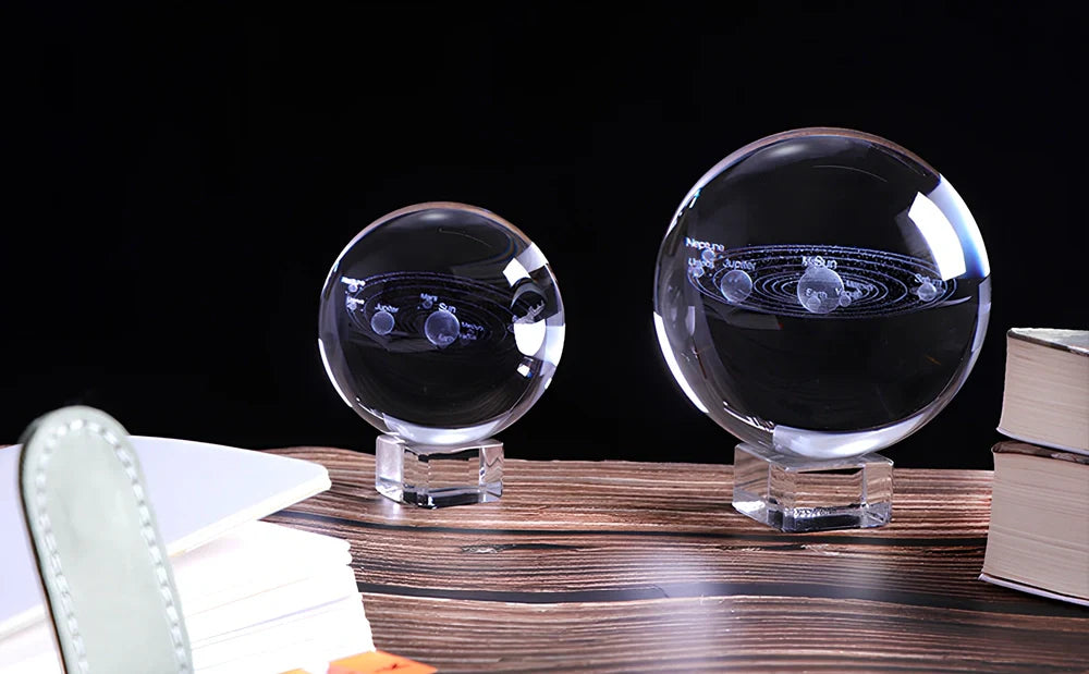 Solar system crystal ball showing planets inside K9 optical crystal sphere on metallic base