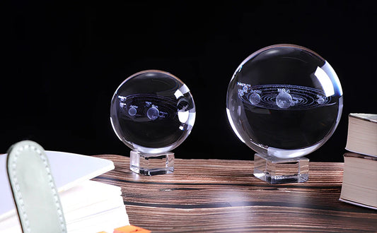 Solar system crystal ball showing planets inside K9 optical crystal sphere on metallic base